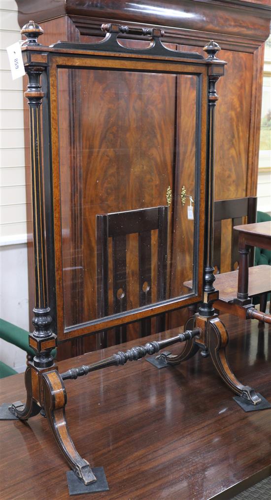 A late Victorian ebonised and thuyawood cheval fire screen with mirrored plate, W.61cm